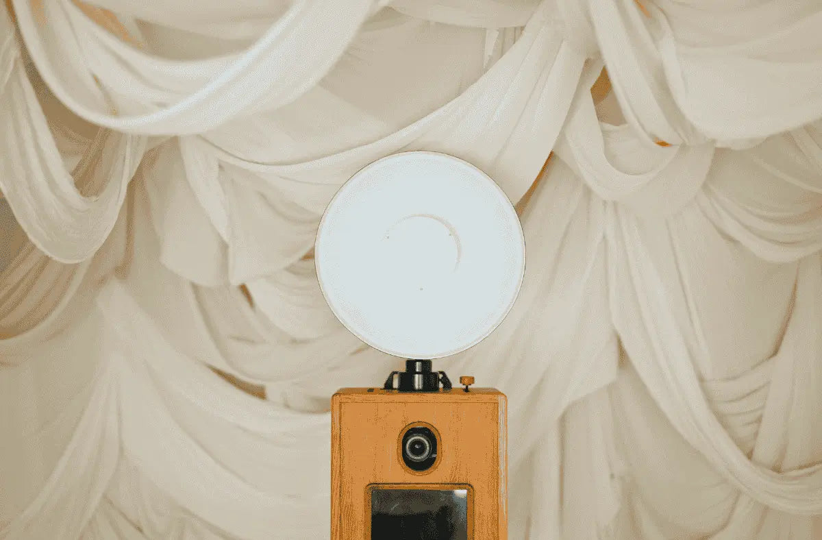 Artisan-crafted Glamour Booth with flash in front of soft draped fabric backdrop