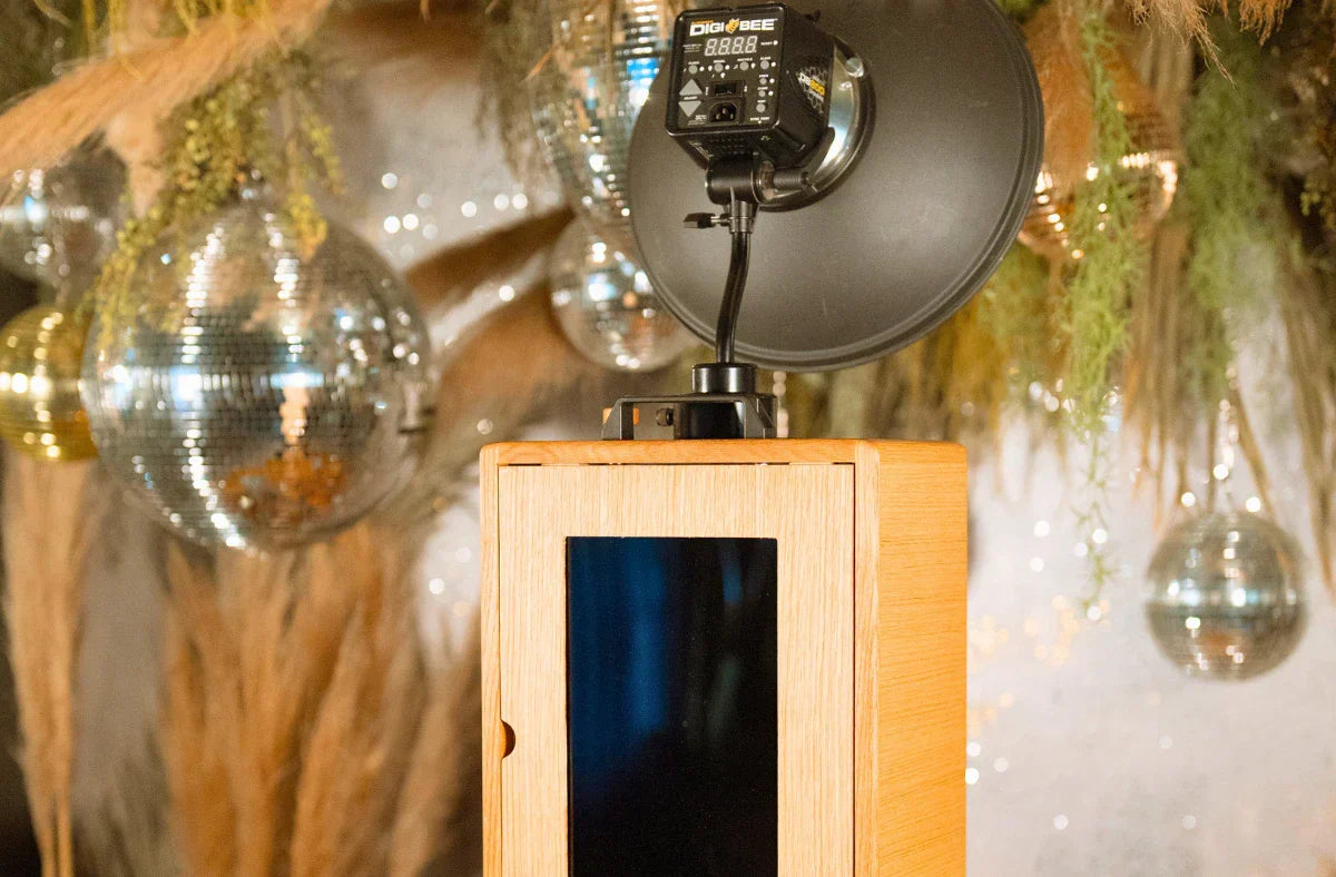 A Glamour Booth with studio light against disco balls and dried floral backdrop