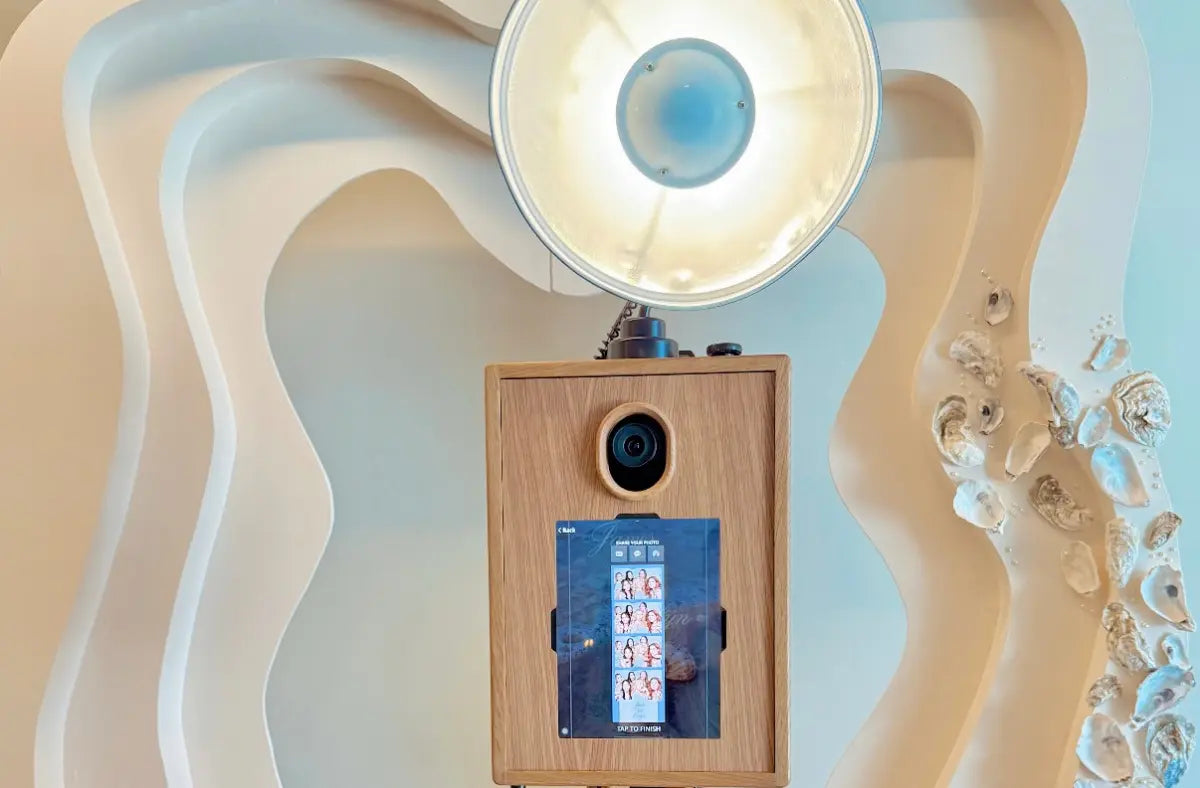 A Glamour Booth with tripod stand and printer shell against modern cream wave backdrop